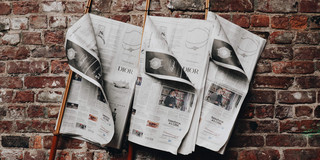 Unsplash Juliana Malta Newspapers on wall
